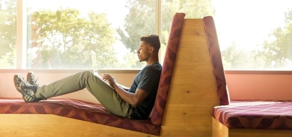 student-sitting-on-bench-writing-cover-letter-on-laptop.jpg