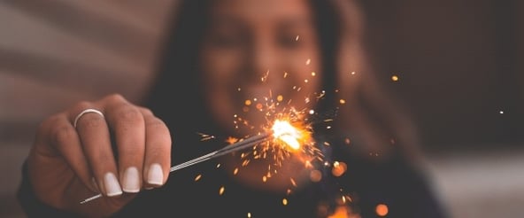 woman-holding-sparkler-in-front-of-camera600x250.jpg